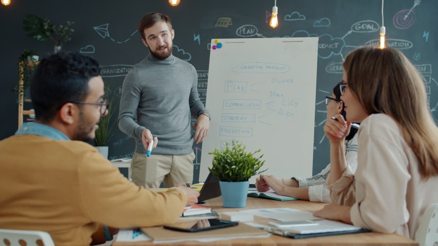 Two people reviewing work together at a whiteboard during a meeting