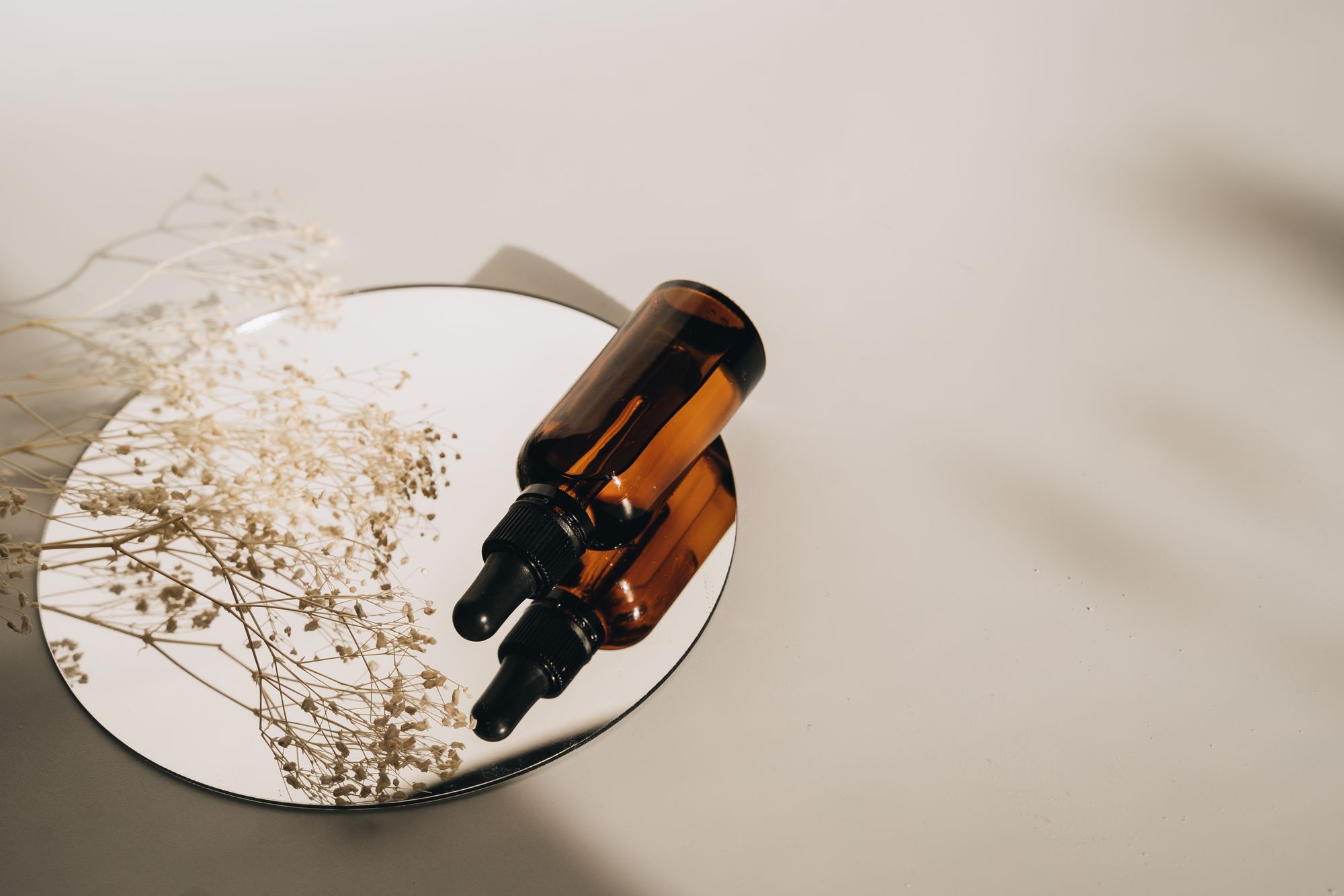 Amber cosmetic bottles in soft daylight