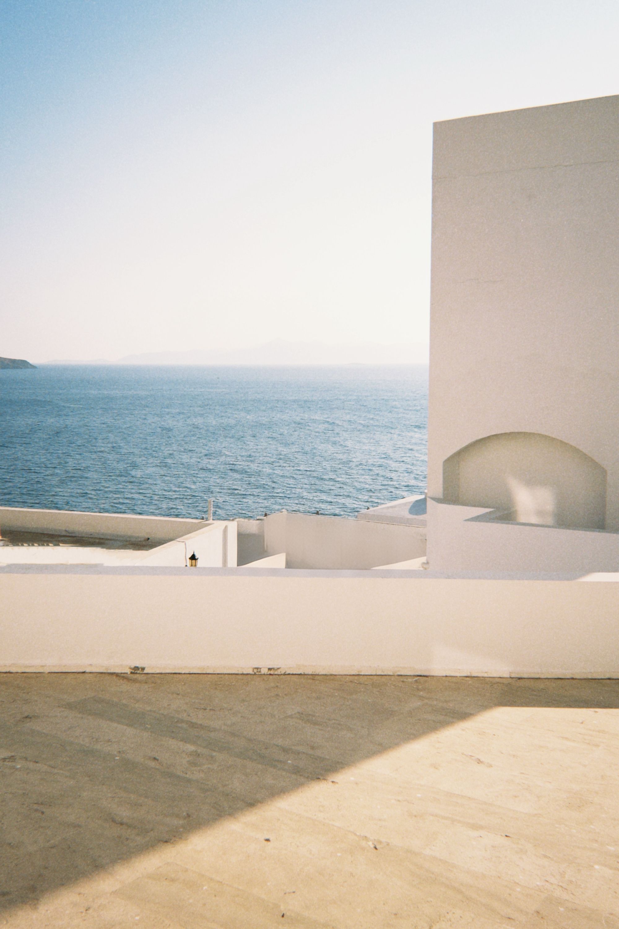 Minimal coastal architecture meeting a clear blue horizon