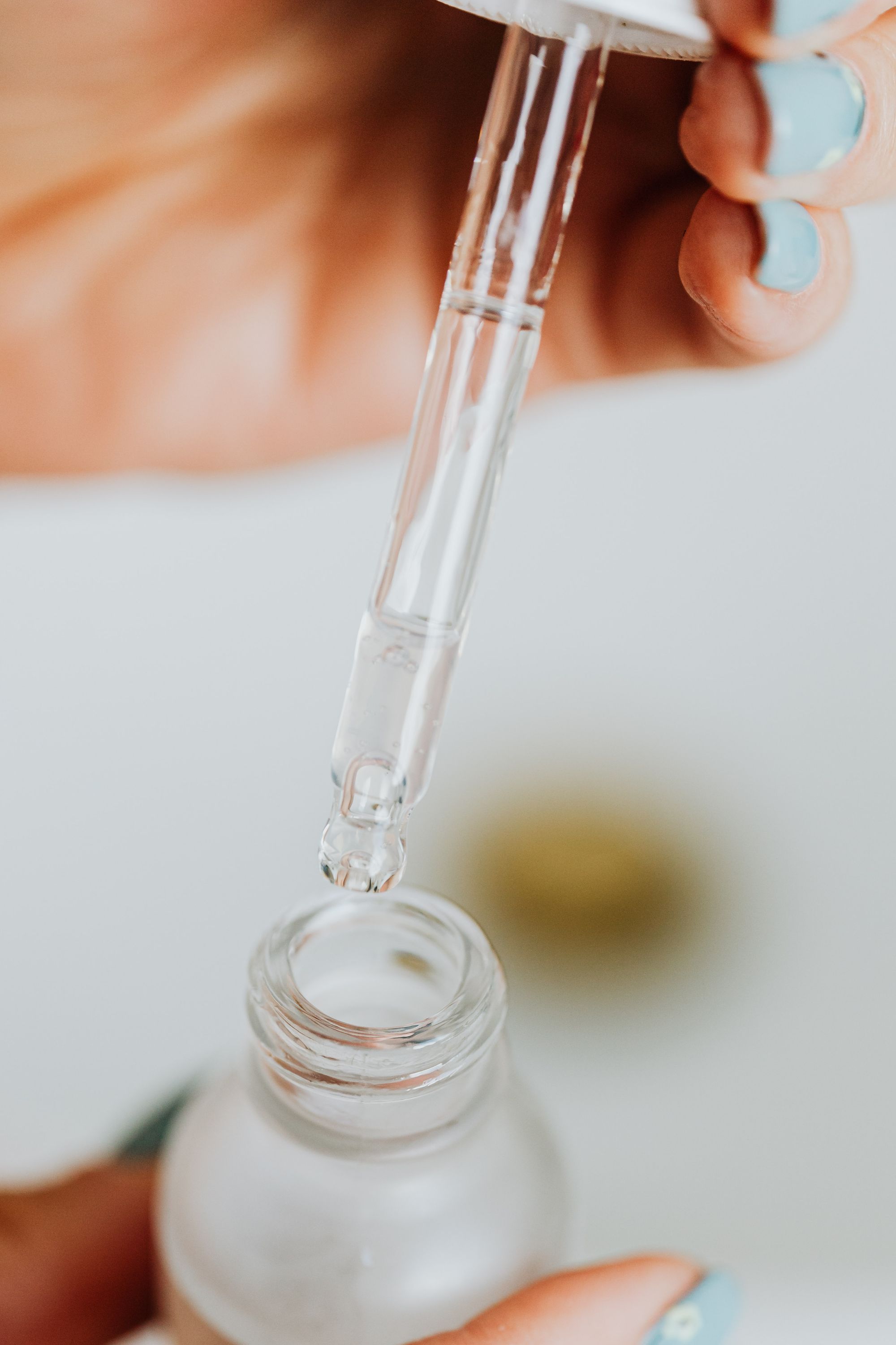 Pipette over a clear cosmetic bottle