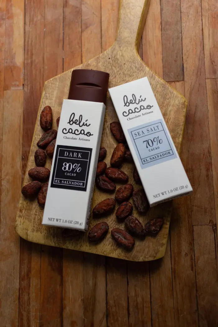 Cacao products on a chopping board with cacao beans