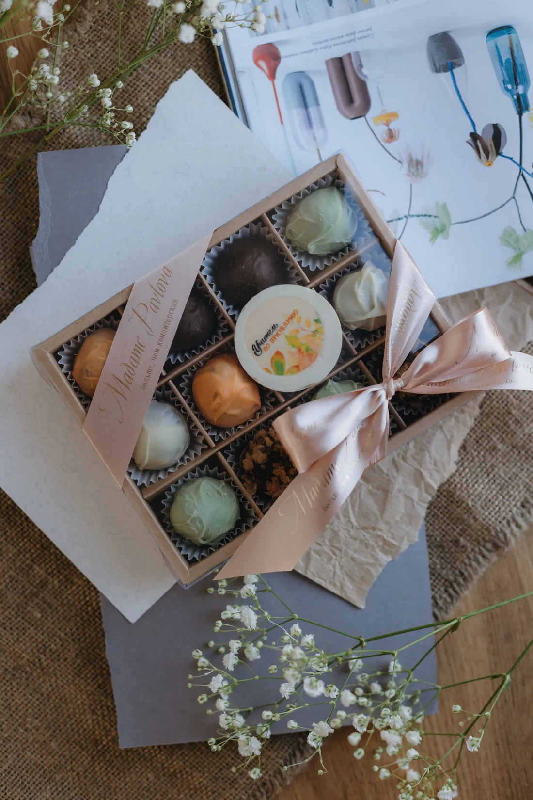 A box of chocolates with flowers and a note