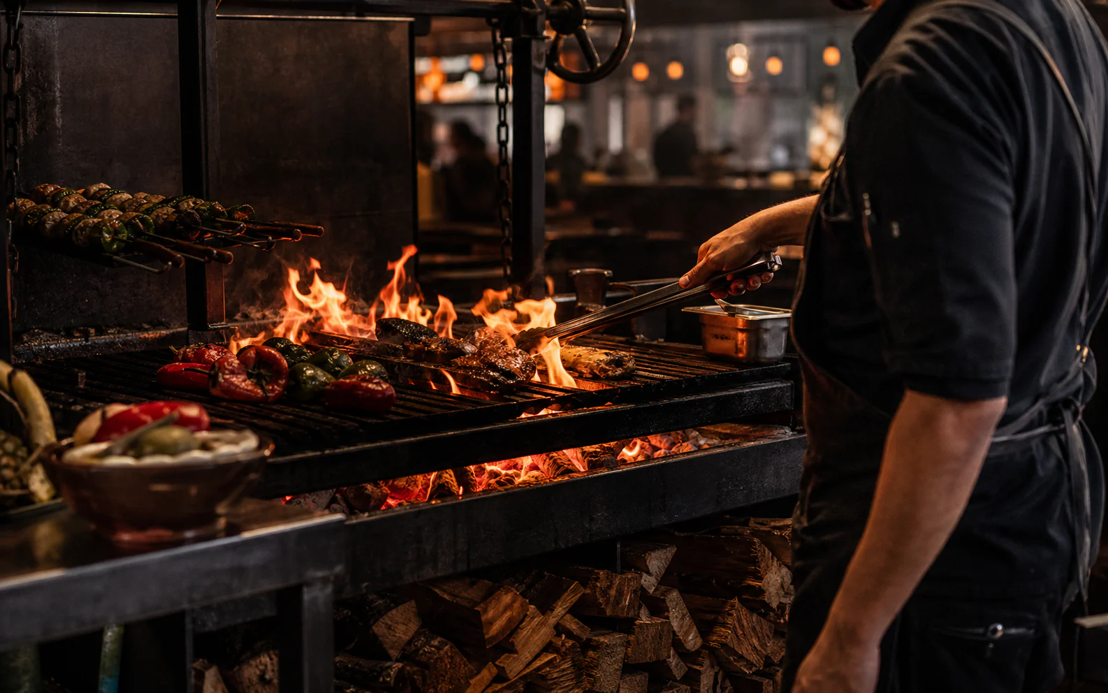 Chef tending the BRASA wood fire