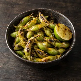 Charred green edamame pods with aji amarillo butter, smoked salt and lime