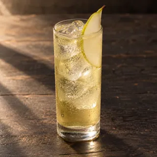 A pale-gold pisco, green tea, pear and lemon highball with sparkling soda, clear ice and a thin pear slice in an unbranded tall clear glass