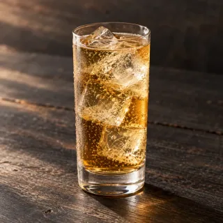 An amber whisky and roasted barley highball with soda in a plain tall glass and large realistic ice cubes. No bottle or branding