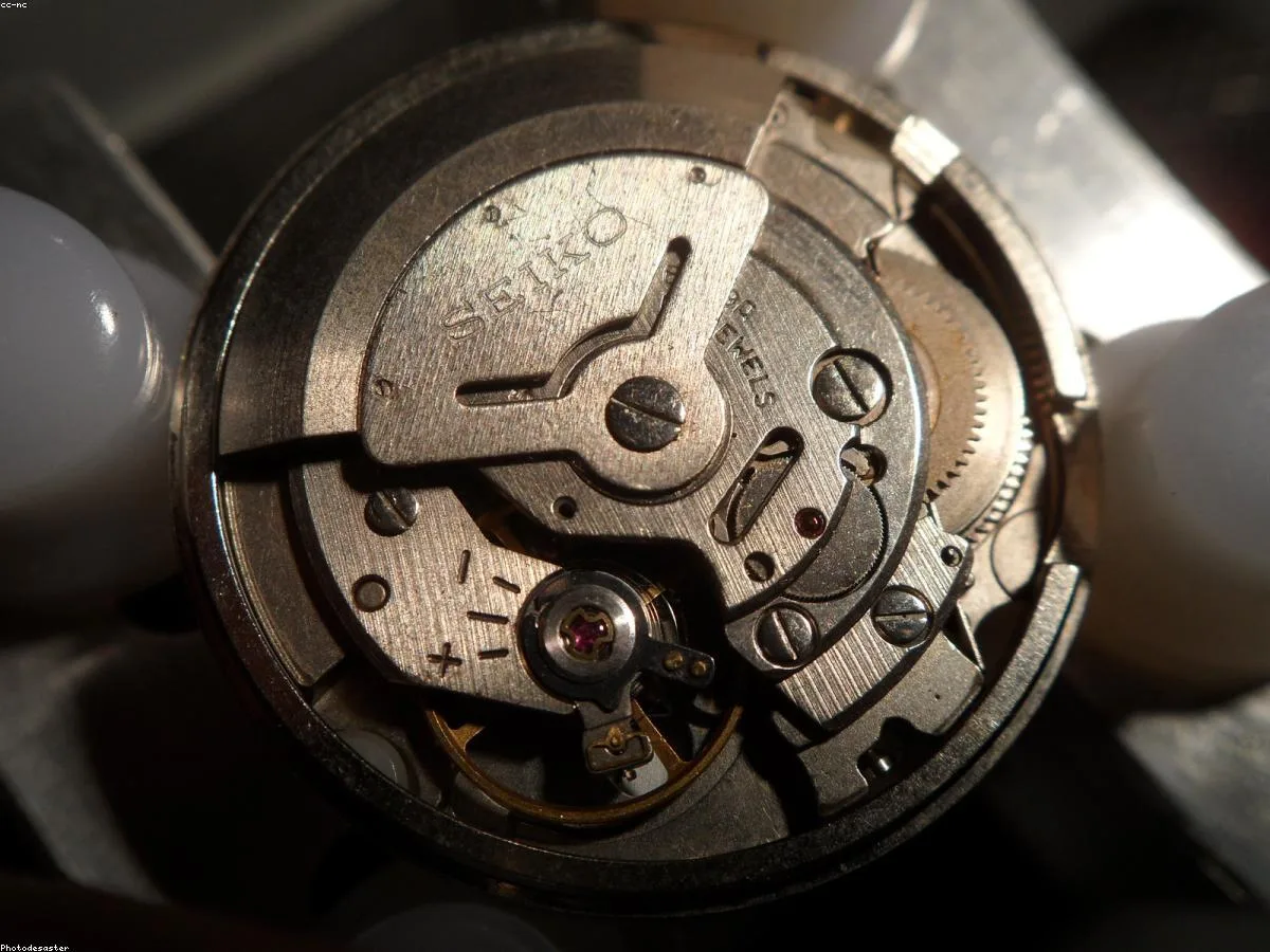 Close-up of a hand-finished mechanical watch movement showing Cotes de Geneve striping