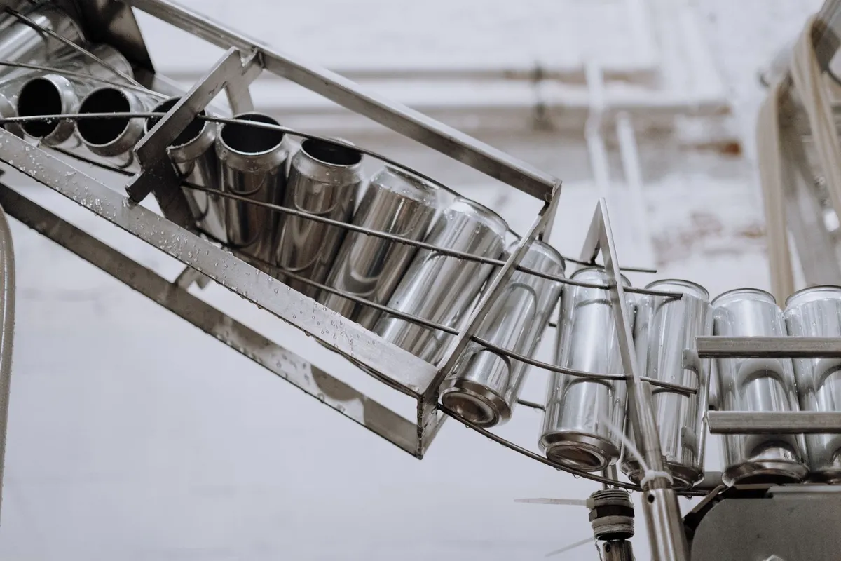 Steel brewing equipment and a rack of aluminum cans in production