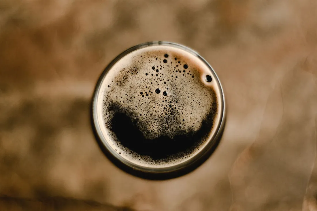 Top-down view of a dark stout with a tan foam head