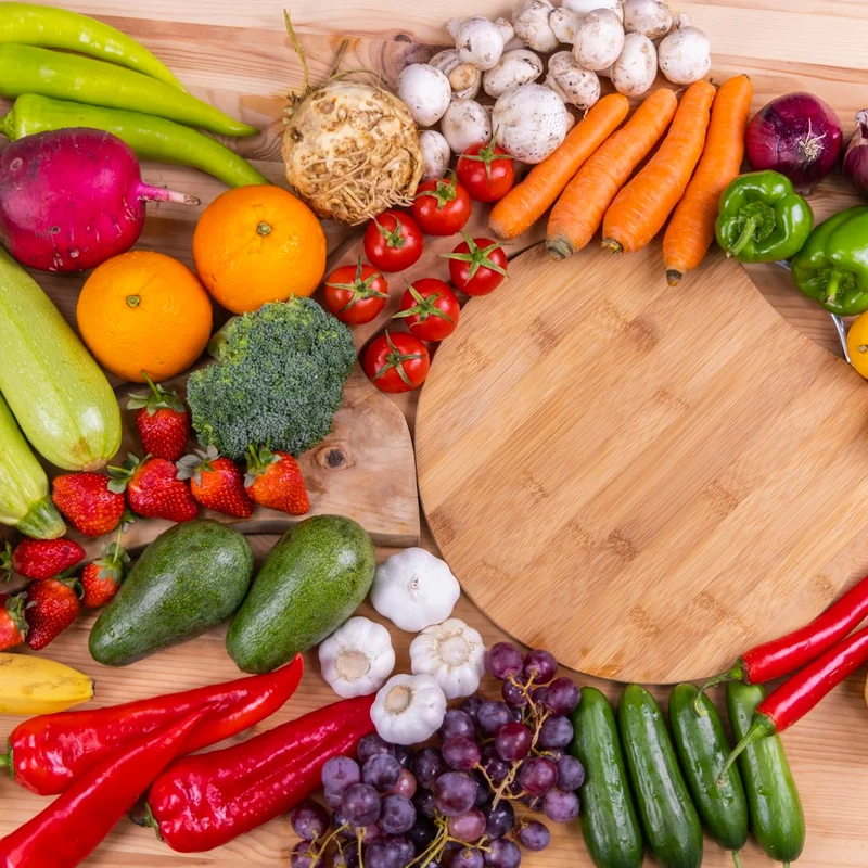 Wooden farm box overflowing with seasonal organic vegetables and leafy greens