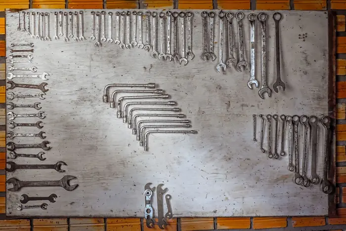 Wrenches organized on a metal board in a workshop