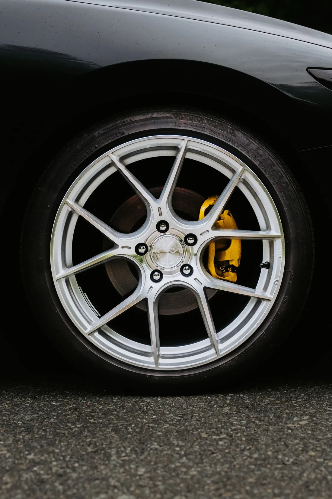 Luxury car wheel with a yellow performance brake caliper