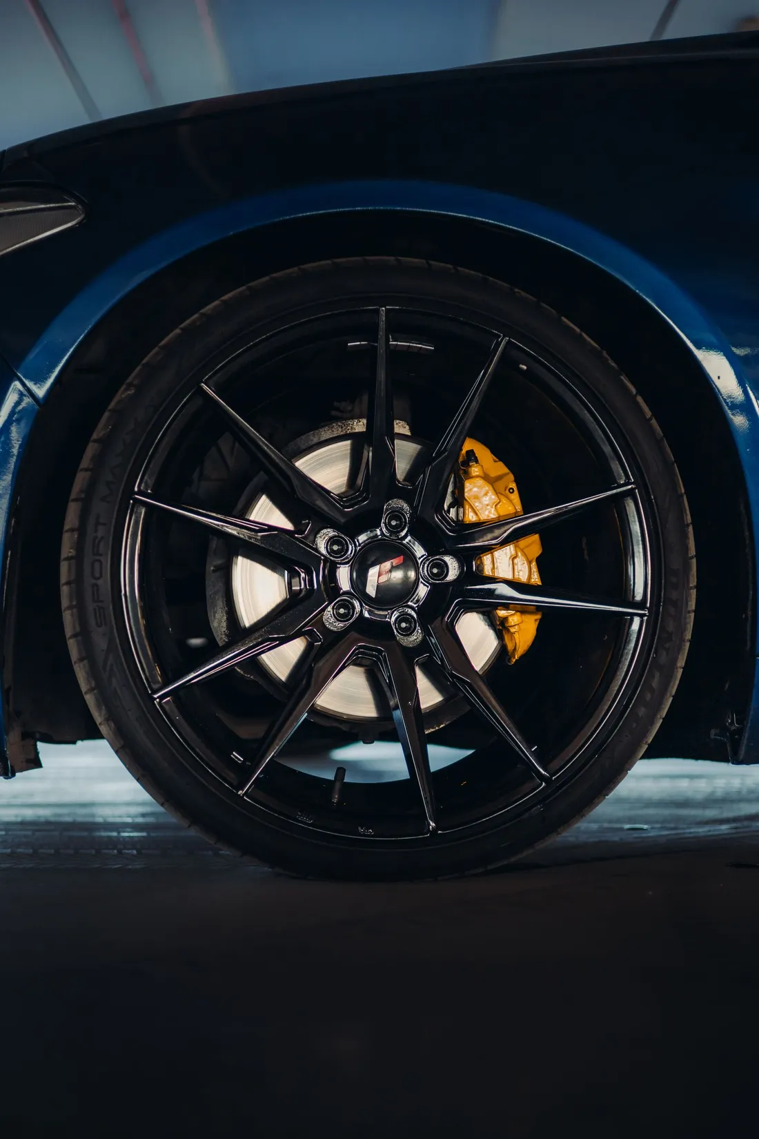 Black alloy wheel with a factory-style brake caliper