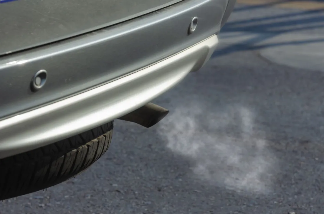 Silver car with a black exhaust pipe
