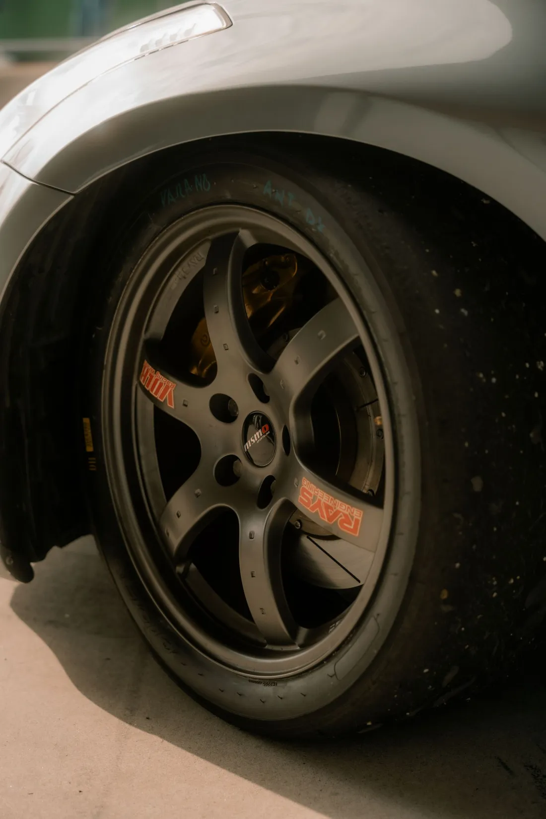 Wheel arch of a lowered, tuned car showing suspension travel