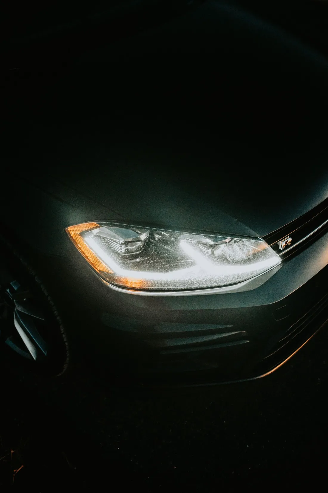 Car headlight glowing in the dark