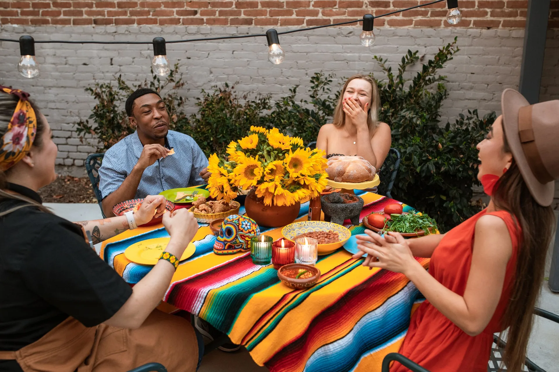 A group of friends laughing together while sitting near a table