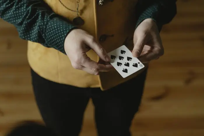A hand holding a playing card
