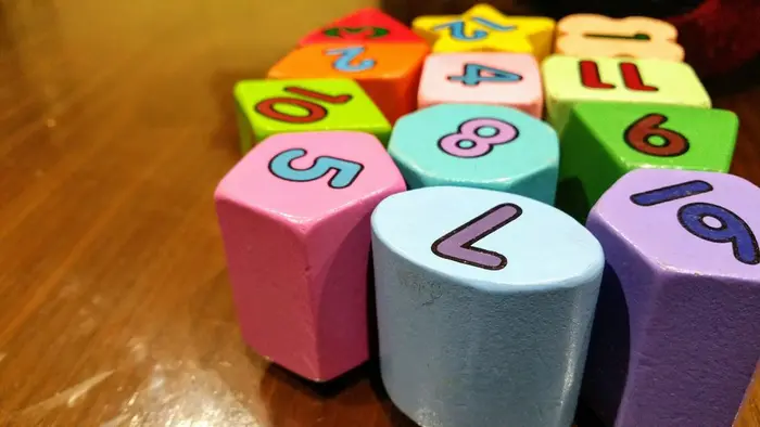 Assorted colour dice on a wooden table