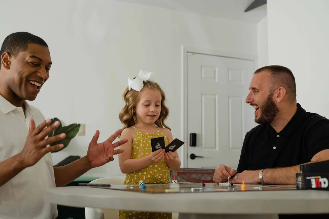 A family playing a card game together at a table
