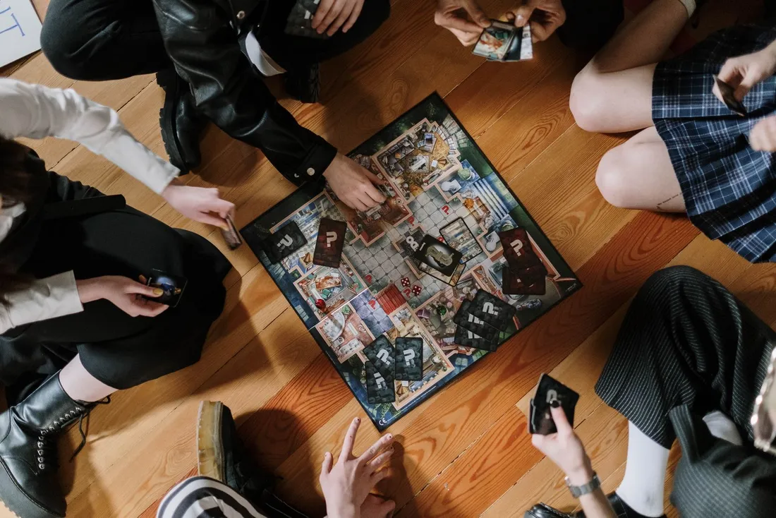 Overhead shot of a group of people playing a board game