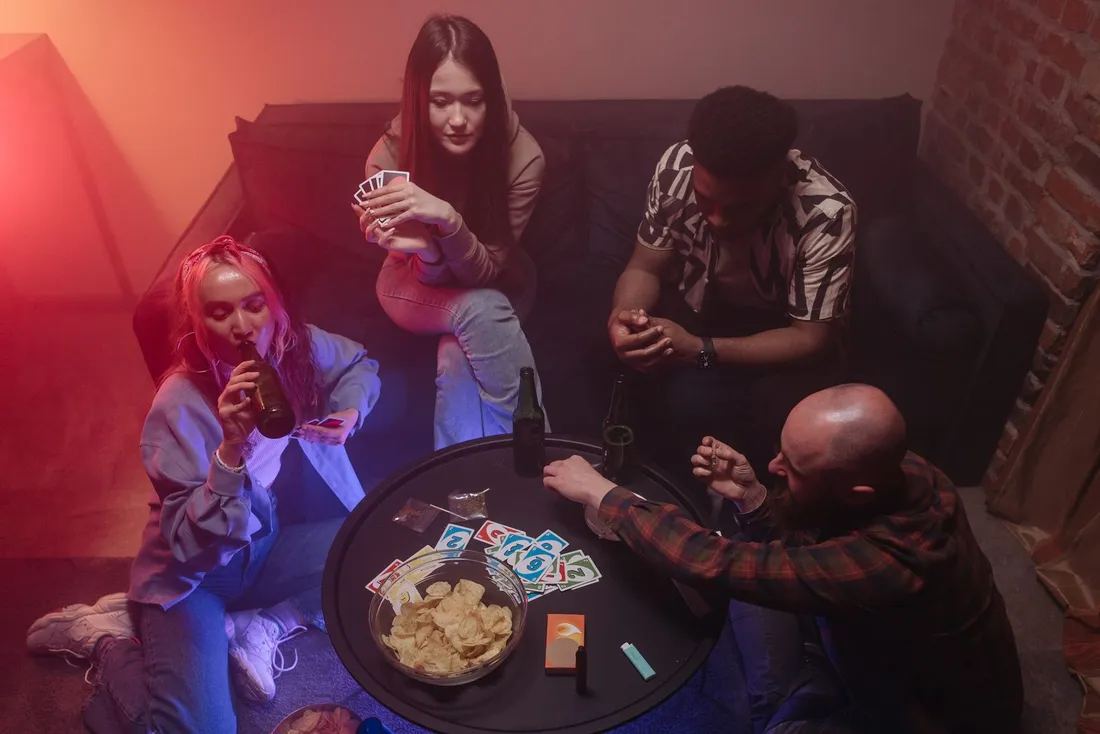 A group of people playing cards together at a table