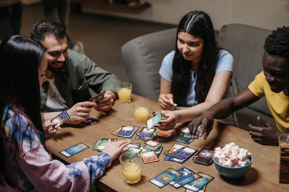 People playing a card game at a table