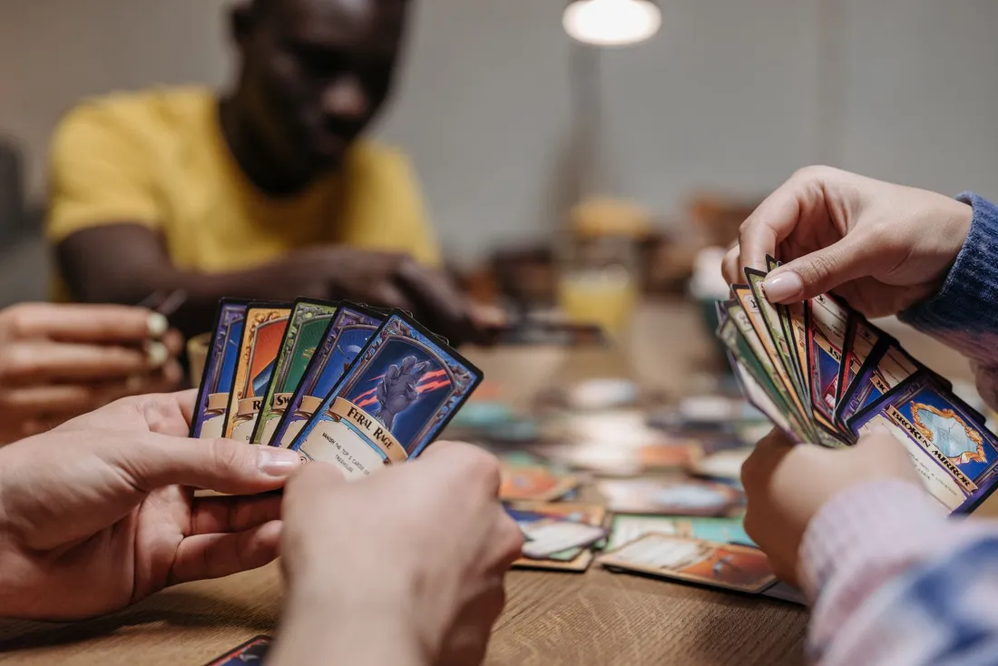 People sitting together playing a card game