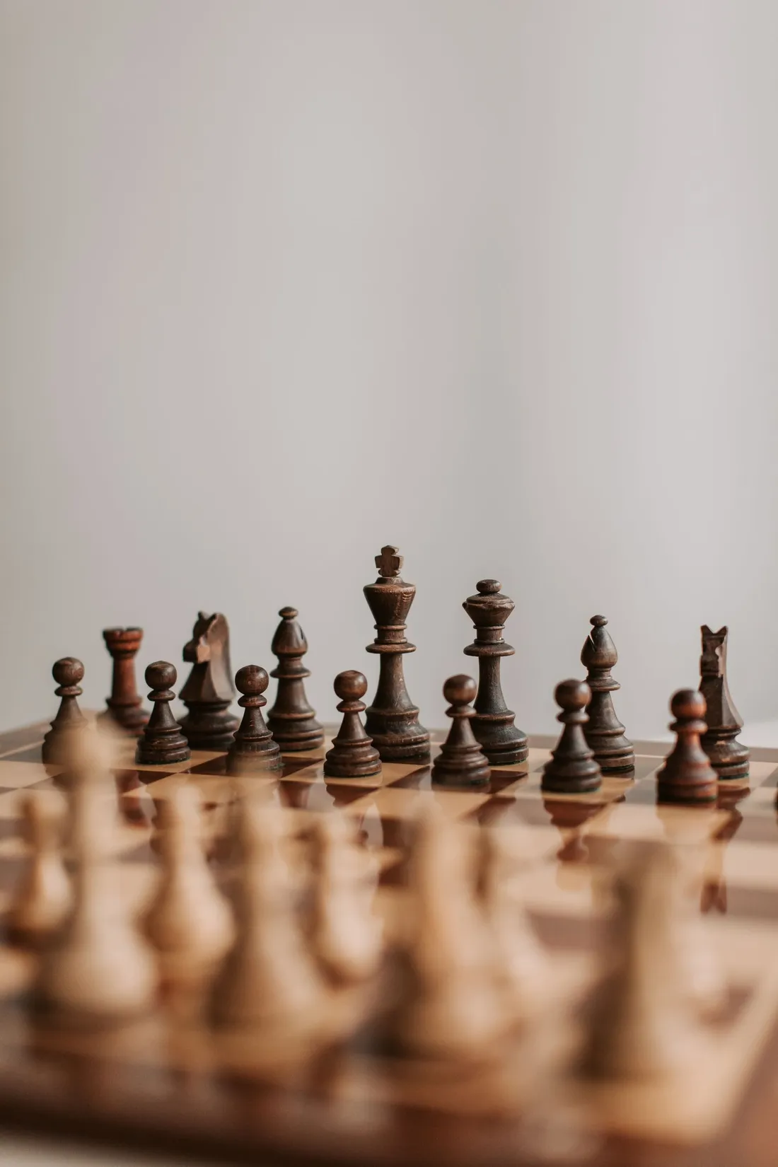 Chess pieces facing off on a chess board