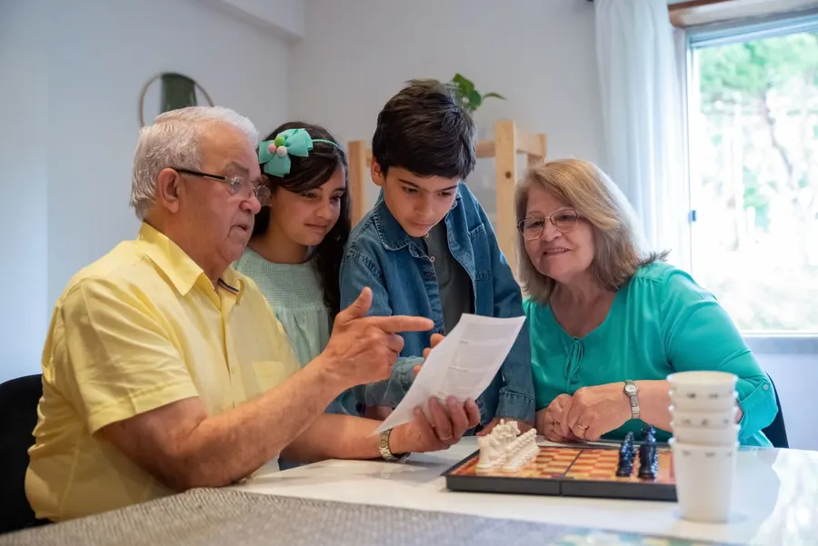 A family reading a game instruction booklet