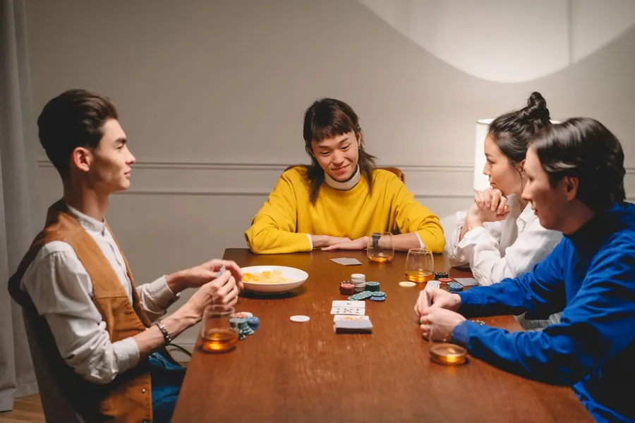 A group of people playing poker together