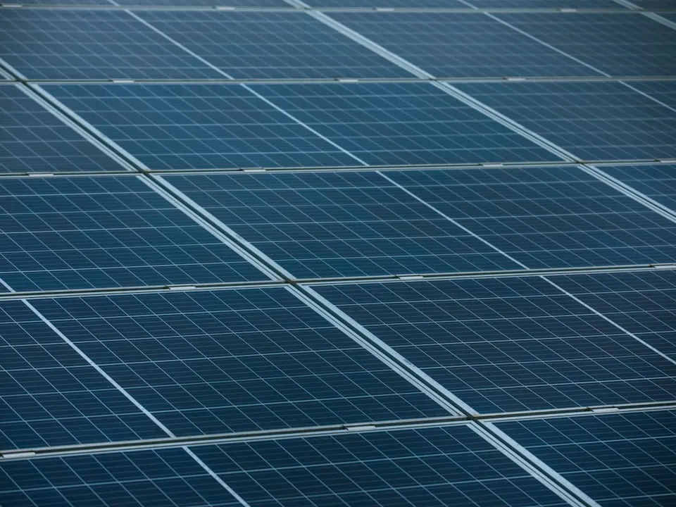 A home with rooftop solar panels installed against a clear sky