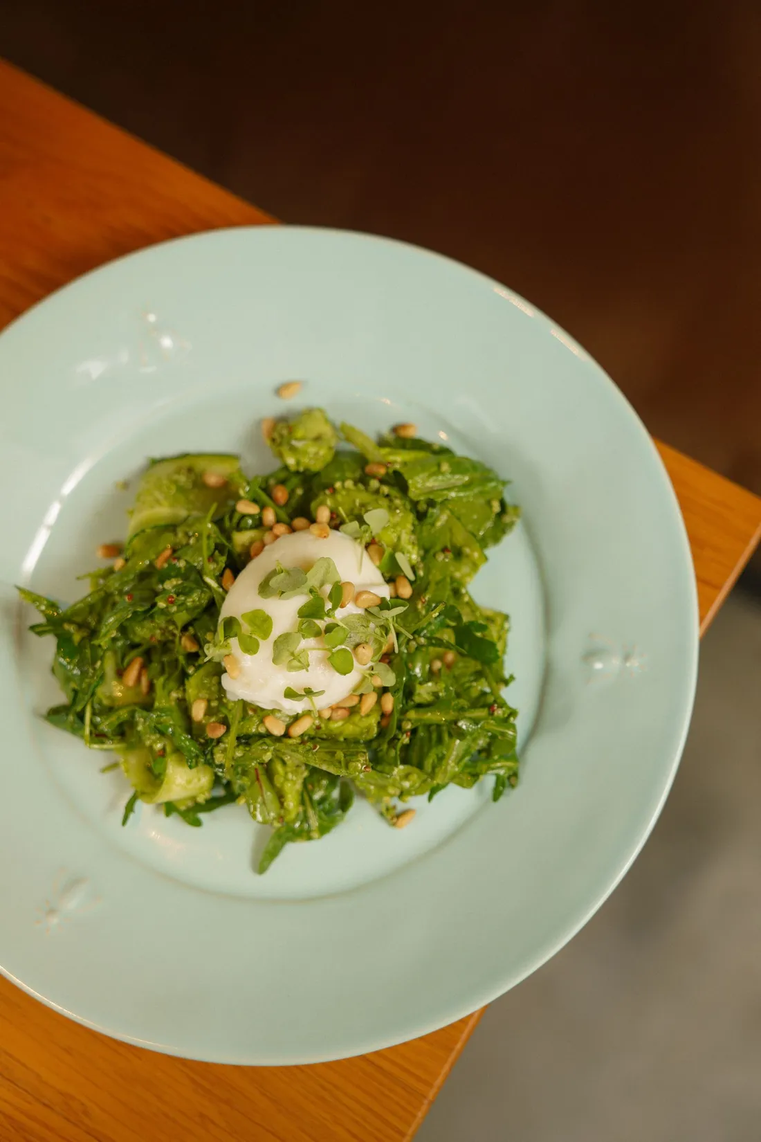 A raw unglazed ceramic charger plate with food