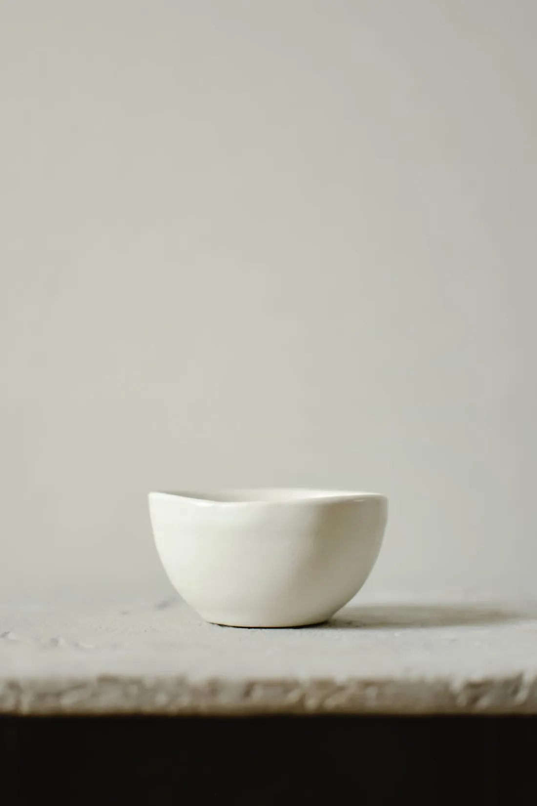 A close-up shot of a white glossy ceramic bowl