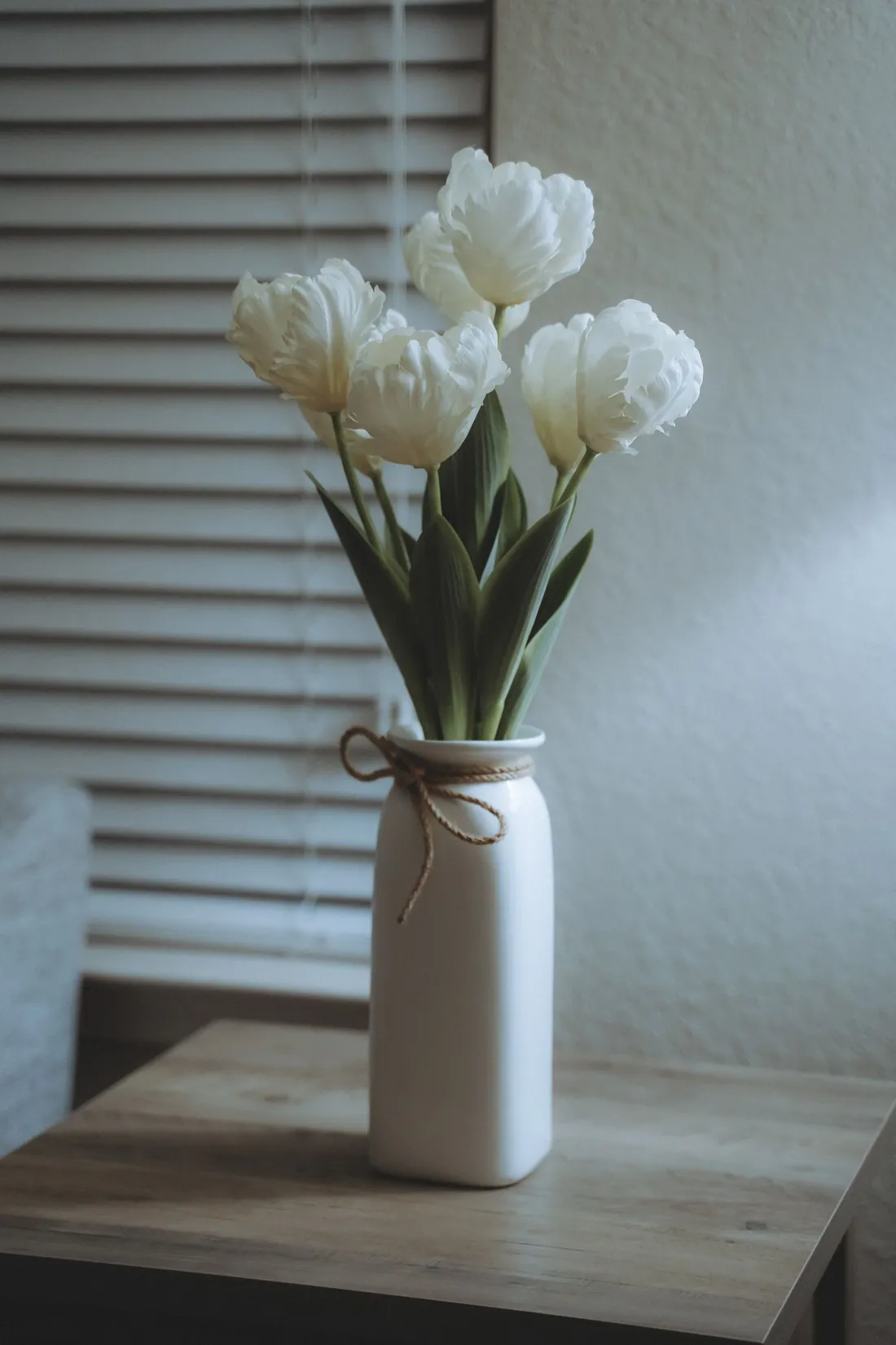 White flowers in a white speckled ceramic vase