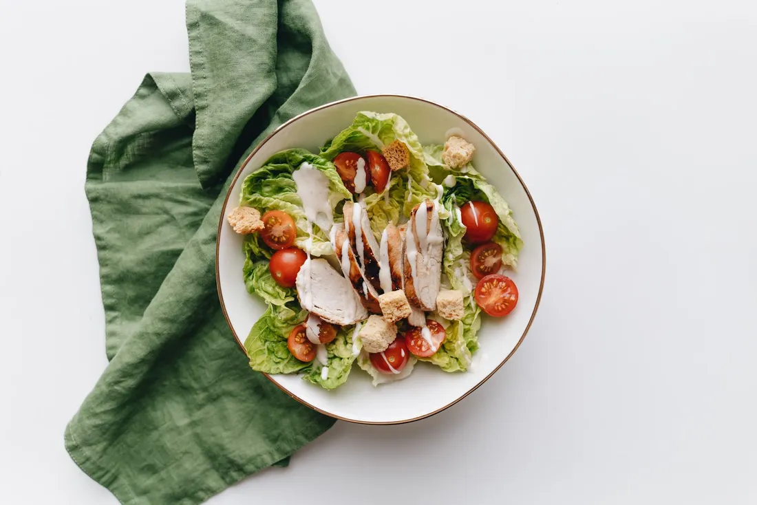 Vegetable salad in a white speckled ceramic bowl