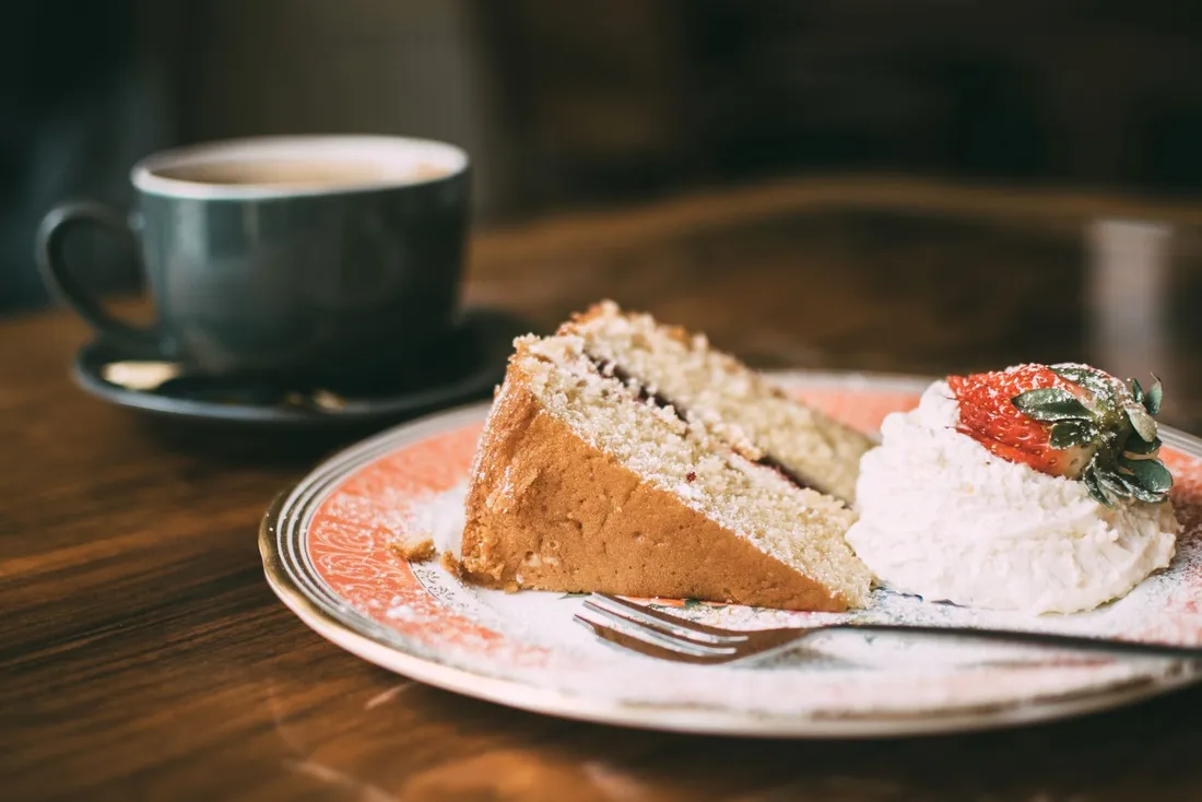 Sliced cake on a glossy white porcelain plate