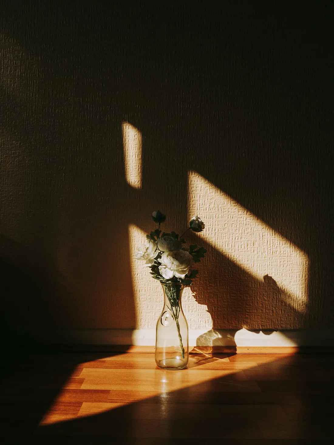 A tall ceramic vase standing on the floor