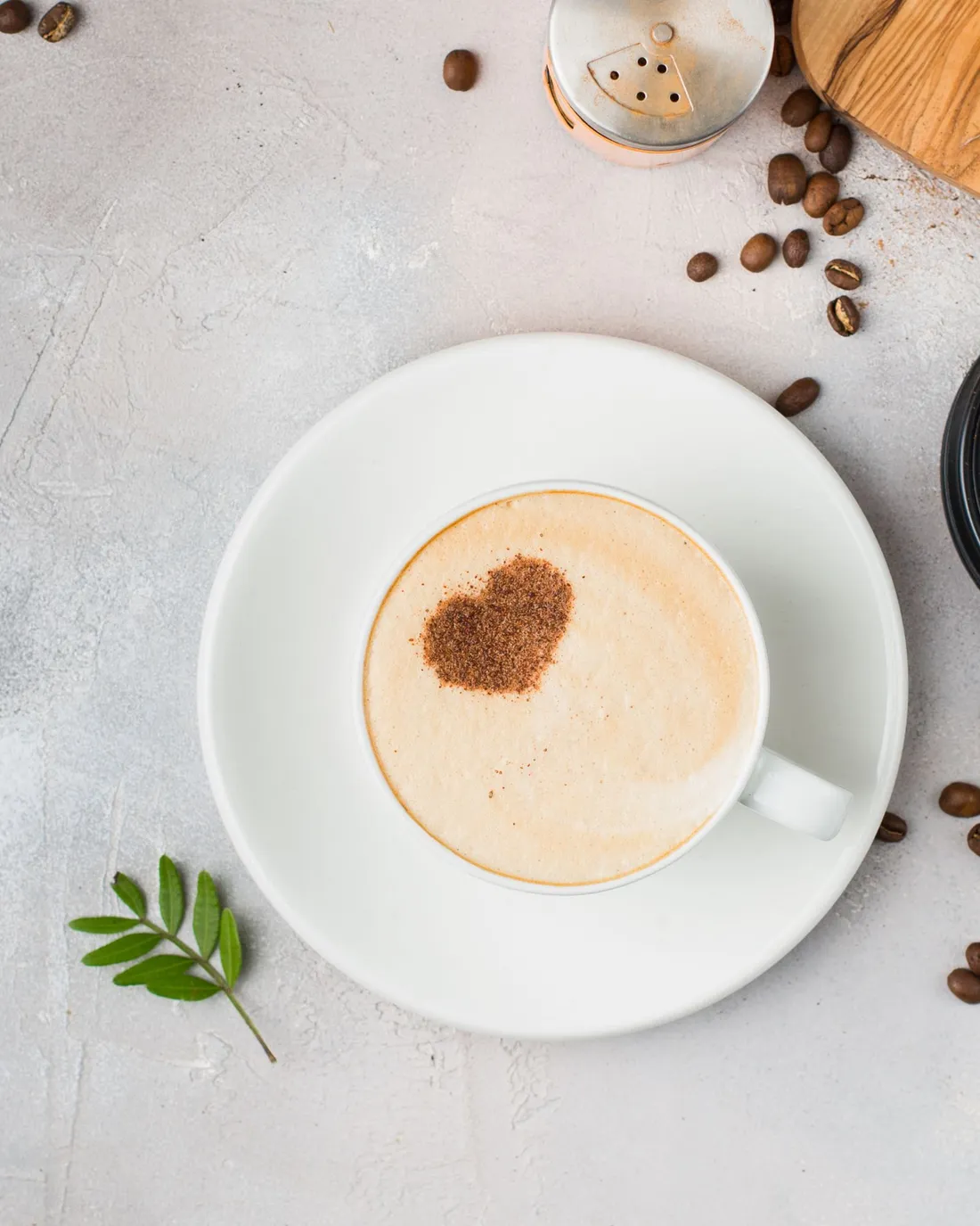 A round white ceramic saucer and coffee cup