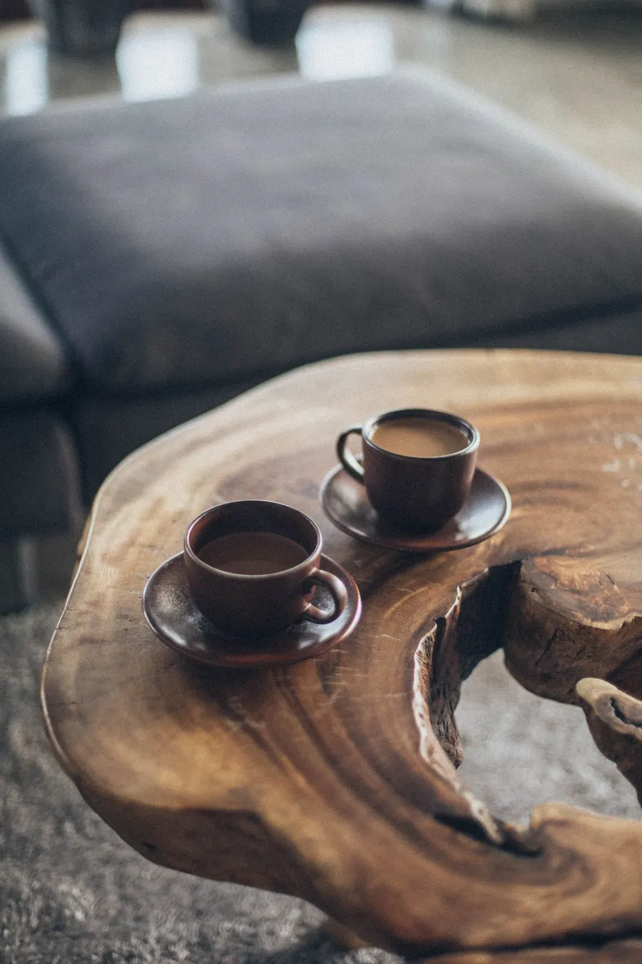 Two brown ceramic mugs on a table