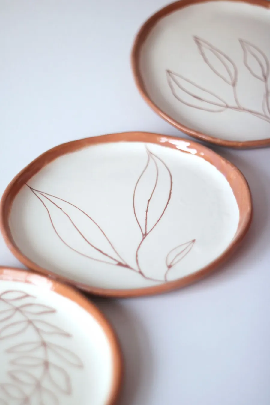 Painted ceramic plates arranged flat