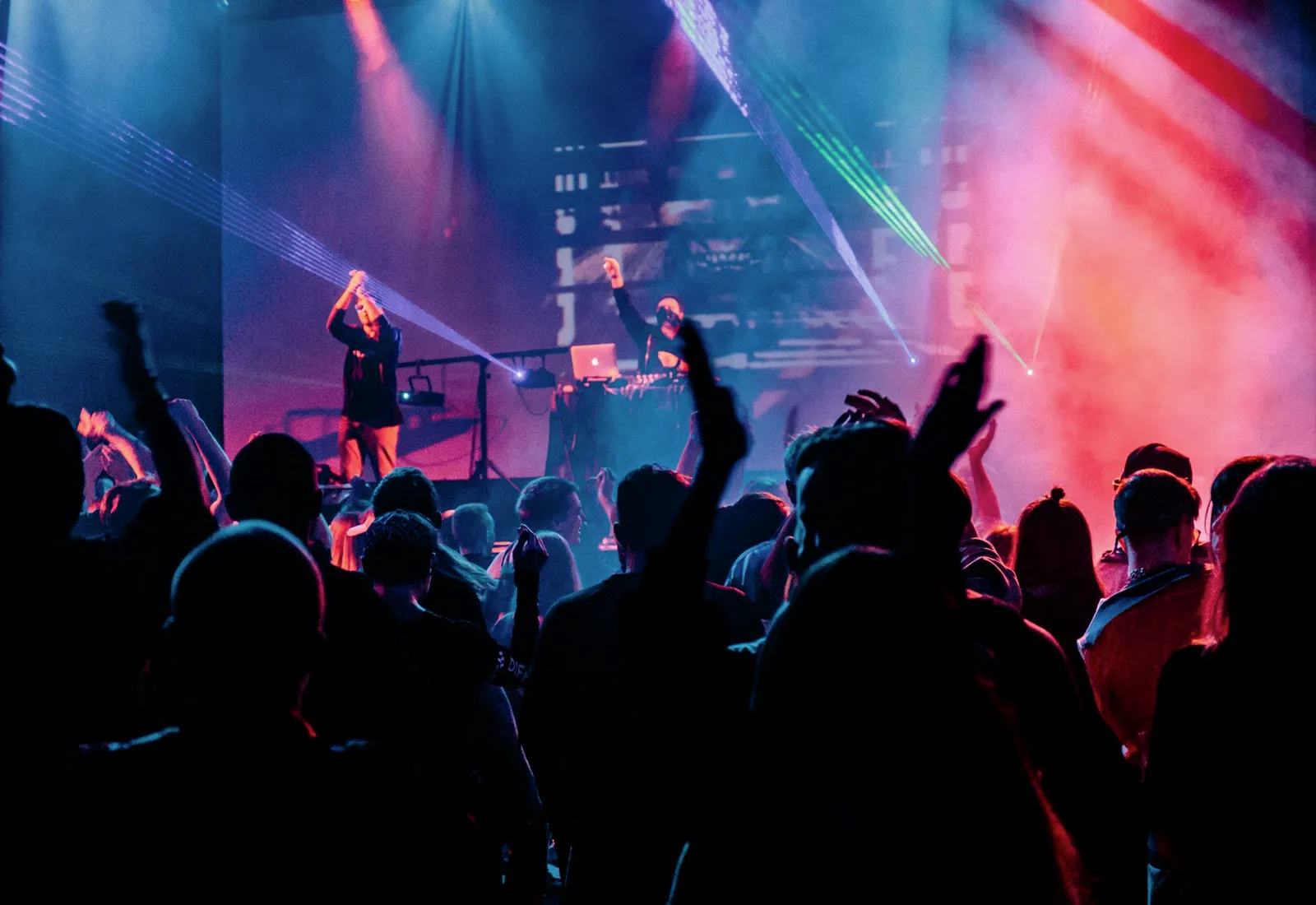 Stage light beams cutting through evening air