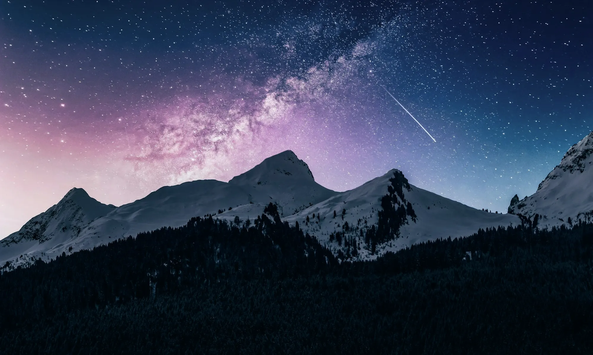 The Milky Way over a dark mountain ridge
