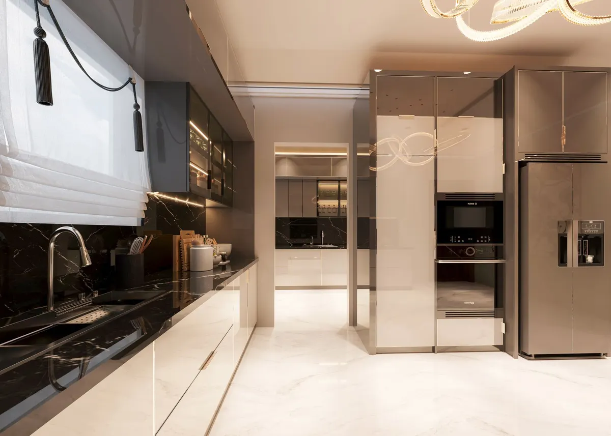 The kitchen's marble island and glass-front cabinetry under a sculptural pendant light