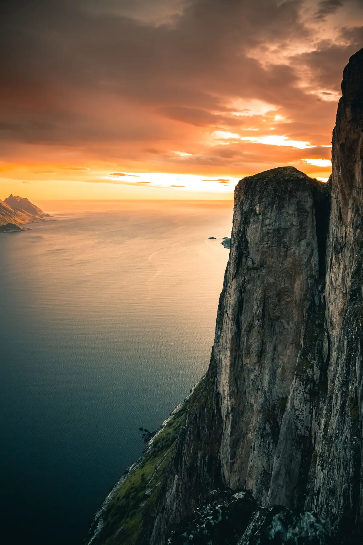 The cliff coastline at sunset, warm light over the water
