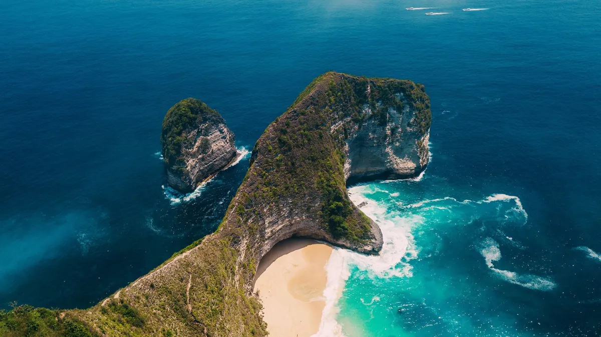 Aerial view of the rocky headland meeting turquoise water below the villa
