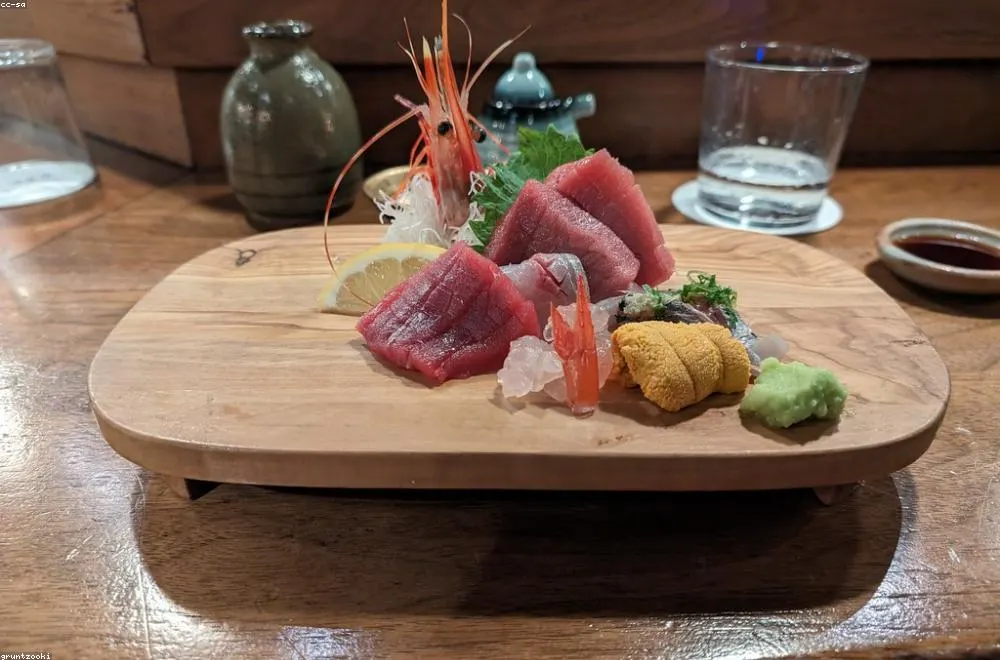 Sashimi course — pristine slices of seasonal fish arranged on a hinoki board at the NORI counter