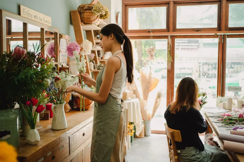 Florists working together arranging flowers in the shop