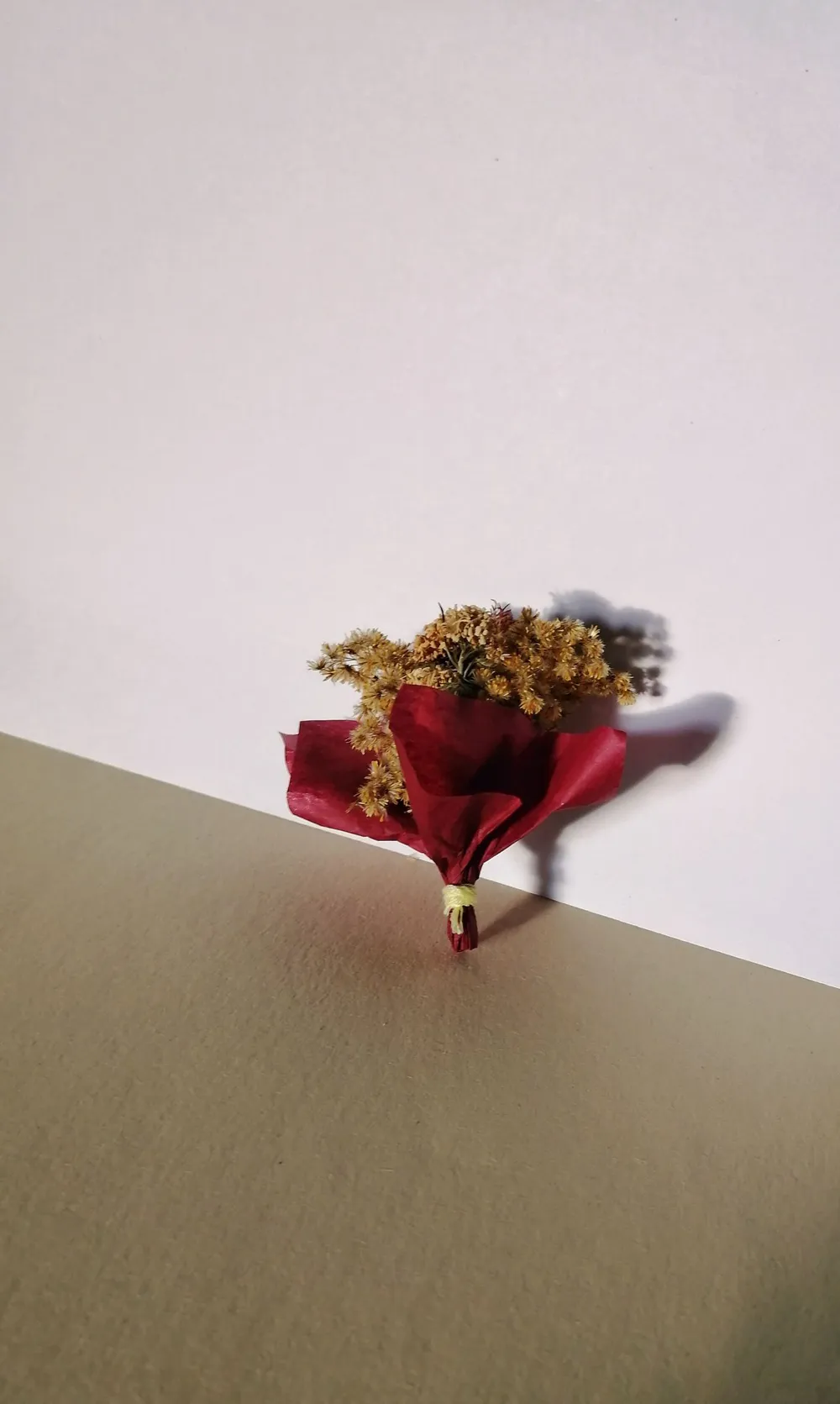 A bunch of flowers wrapped in kraft paper