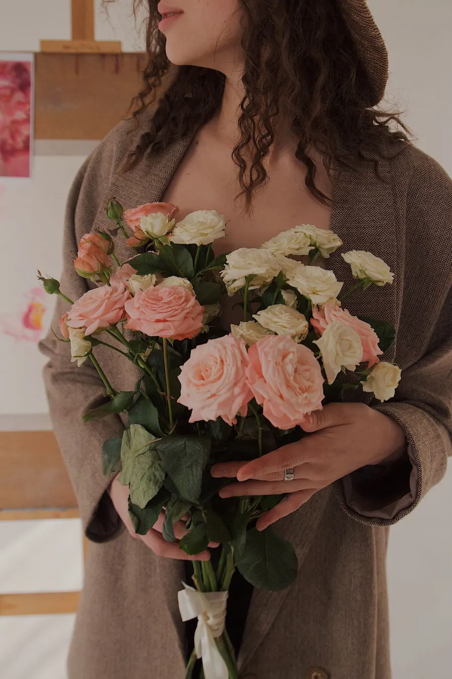 A woman holding a bouquet of roses